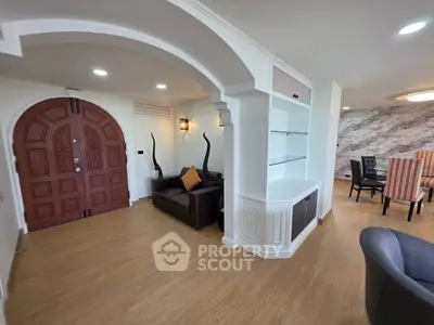 Elegant living room with arched doorway and modern decor