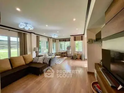 Spacious living room with modern decor and large windows for natural light