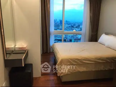 Cozy bedroom with city view, featuring a comfortable bed and elegant decor, perfect for urban living.