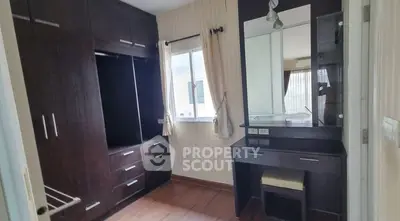 Spacious bedroom with built-in wardrobe and vanity in modern apartment