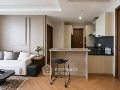 Modern open-layout kitchen and living room with sleek design and neutral tones.