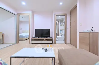 Modern living room with sleek TV setup and cozy seating area