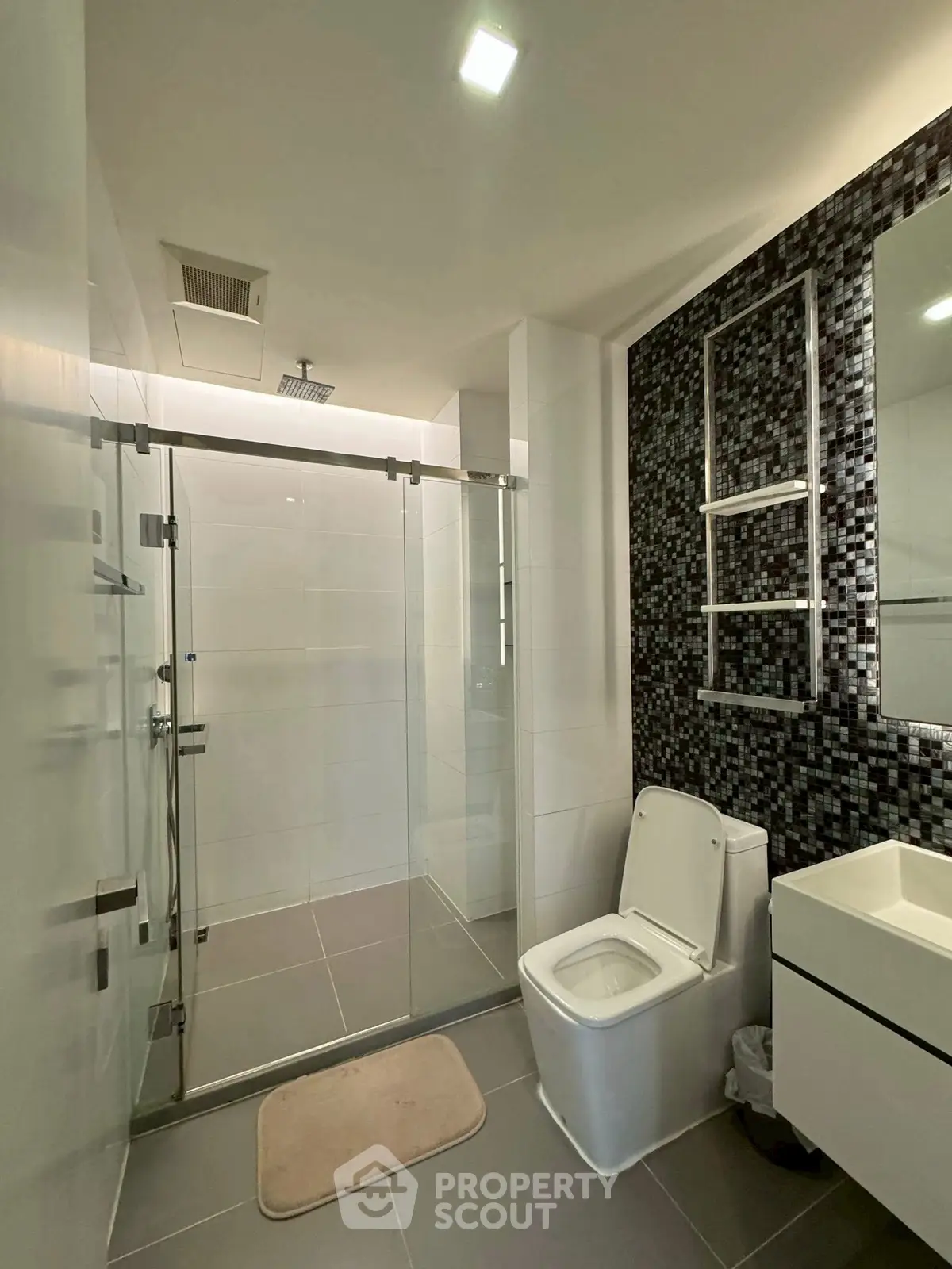 Modern bathroom with glass shower and sleek tile design