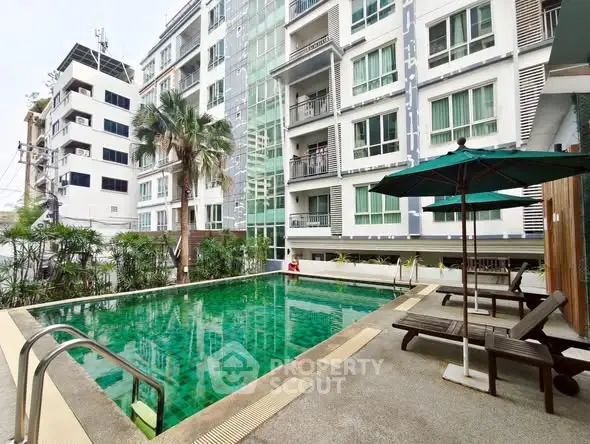 Luxurious condo with a serene poolside view and modern amenities.