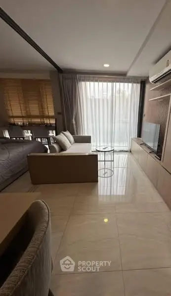 Modern living room with sleek design and large windows for natural light.
