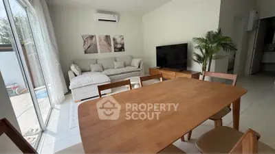Spacious living room with modern furniture and large windows for natural light