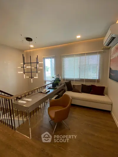Modern living room with stylish lighting and cozy seating area, perfect for relaxation.