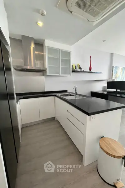 Modern kitchen with sleek black countertops and open layout design