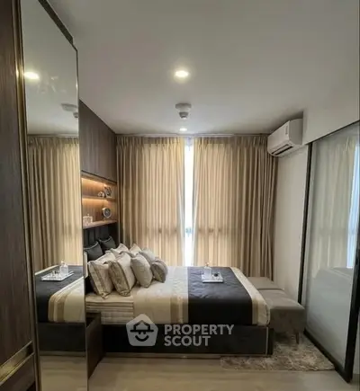 Luxurious bedroom with elegant decor and ample natural light, featuring a cozy bed and stylish furnishings.