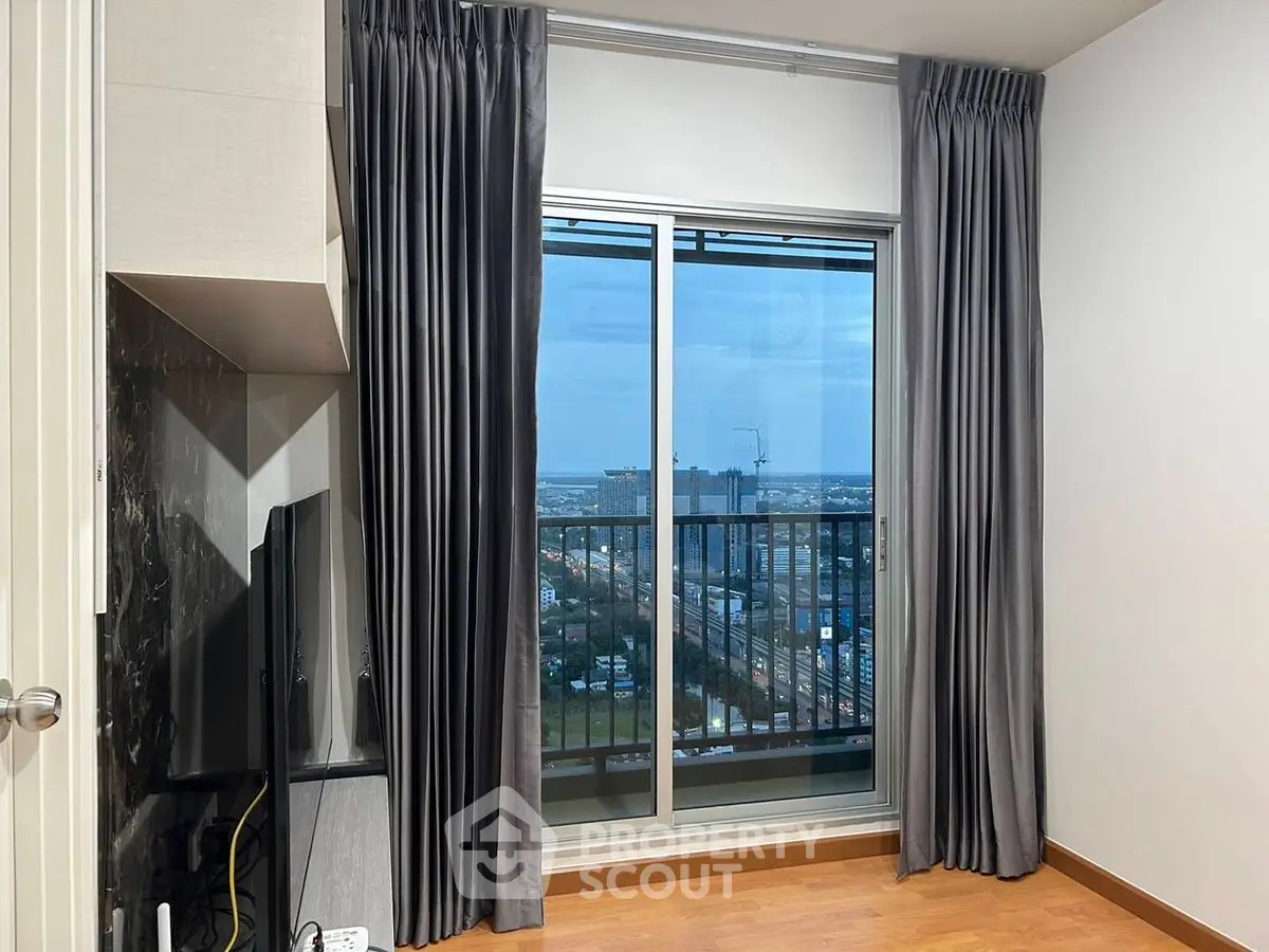 Modern apartment with floor-to-ceiling window and city view