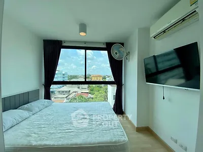 Bright bedroom with large window and city view, featuring modern amenities and minimalist design.