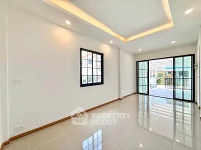 Spacious modern living room with glossy tiled floors and large windows for natural light.