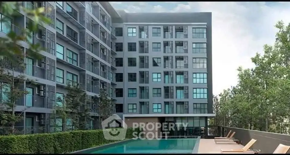 Modern apartment building with pool and lush greenery, perfect for urban living.