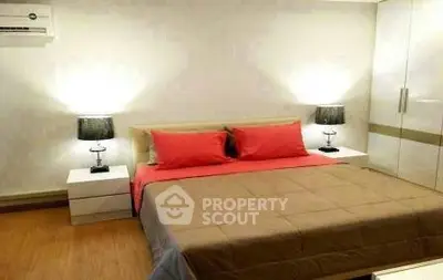 Modern bedroom with stylish decor and cozy lighting, featuring a comfortable bed and sleek furniture.