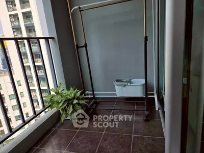 Modern balcony with potted plant and city view, ideal for urban living.