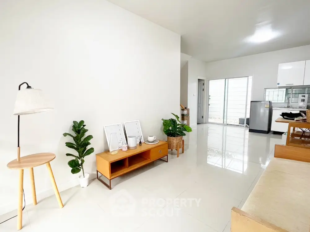 Modern living room with minimalist decor and open kitchen layout