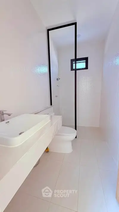 Modern minimalist bathroom with sleek fixtures and natural light
