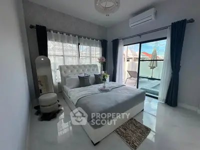Luxurious bedroom with elegant decor and balcony access in modern home