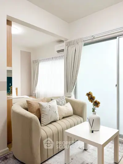 Cozy living room with elegant sofa and natural light, perfect for relaxation.