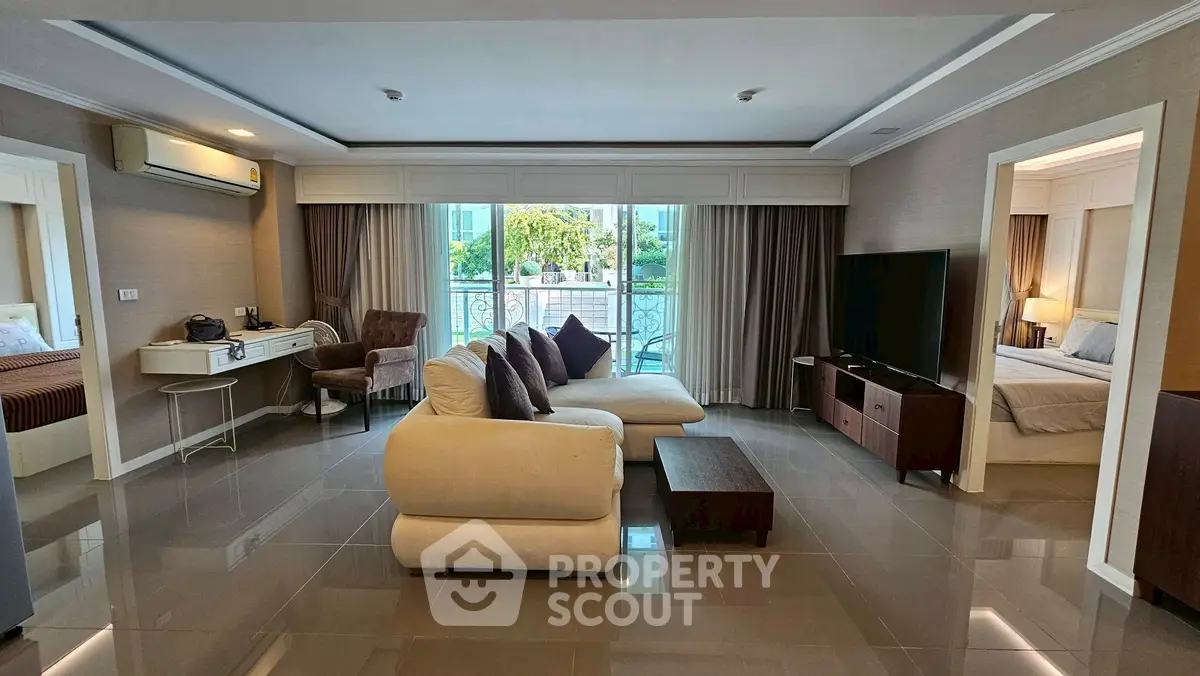 Spacious living room with modern decor and large windows for natural light.
