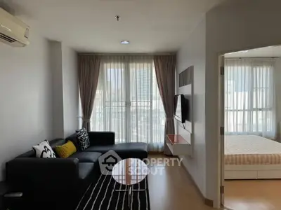 Modern living room with sleek furniture and large windows in a stylish apartment.