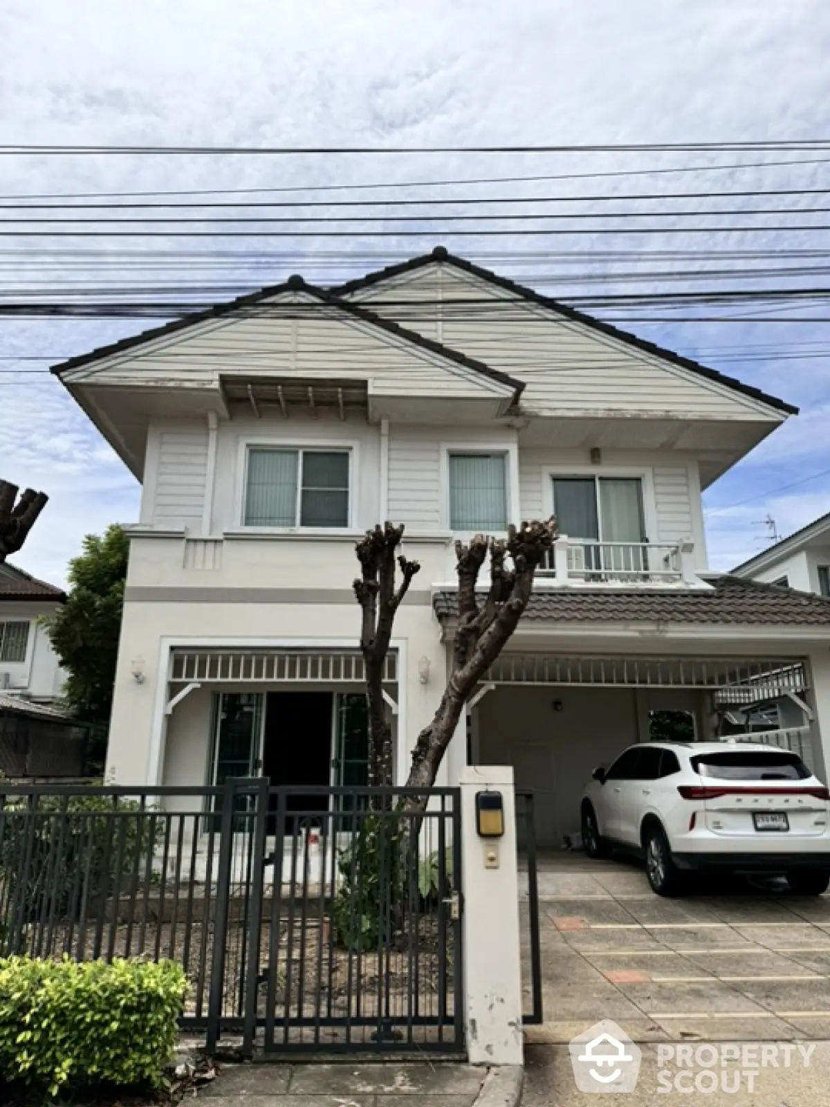 Charming two-story house with garage and modern facade in a serene neighborhood.