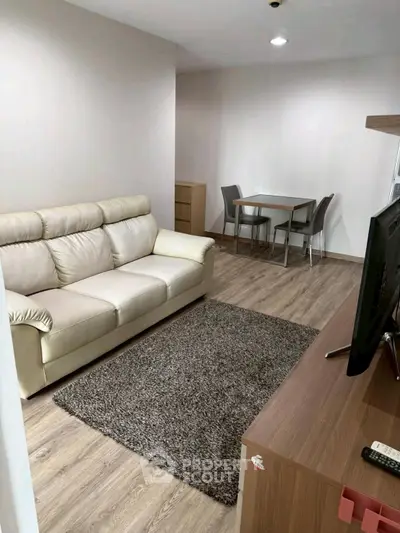 Modern living room with cozy sofa and dining area in stylish apartment.
