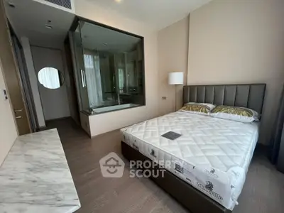 Luxurious modern bedroom with glass wall bathroom and elegant furnishings