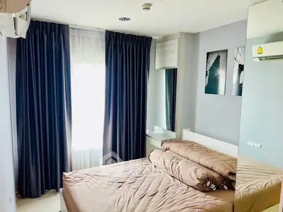 Cozy bedroom with modern decor and ample natural light