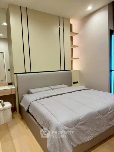 Modern bedroom with sleek design and cozy ambiance, featuring a stylish bed and elegant decor.