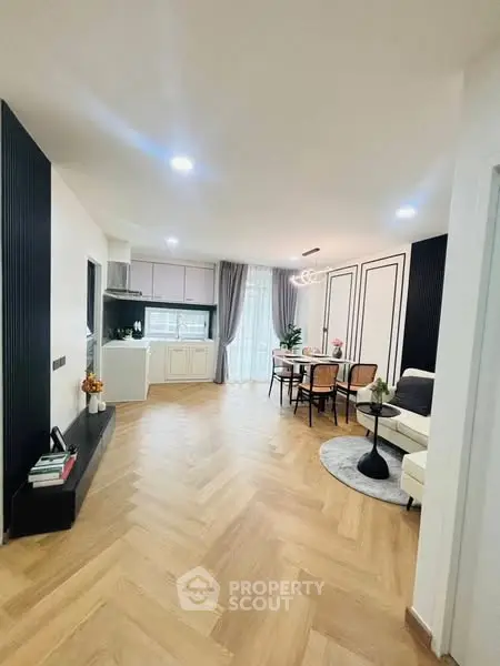 Spacious open-plan living and dining area with modern kitchen and elegant decor.