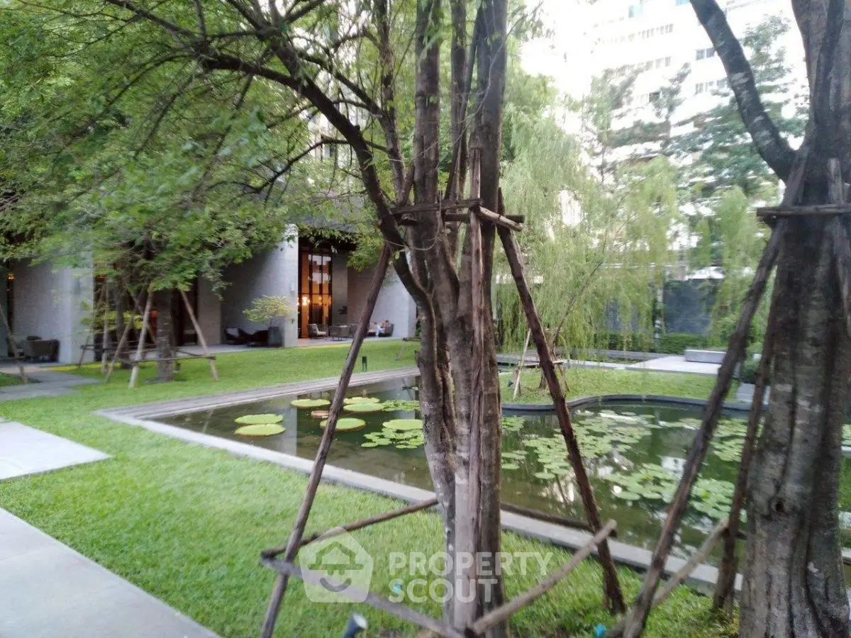 Luxurious garden with serene pond and lush greenery in upscale property