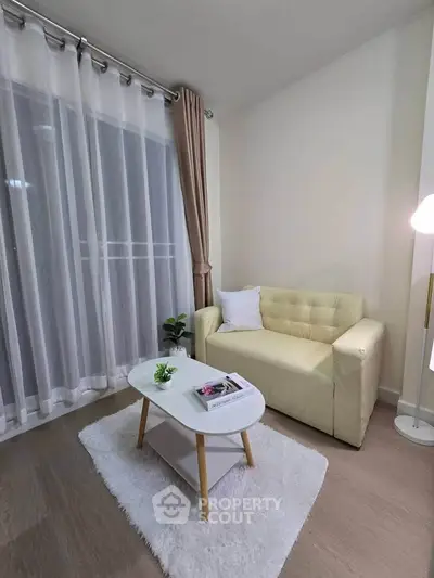Cozy living room with beige sofa, white rug, and modern decor