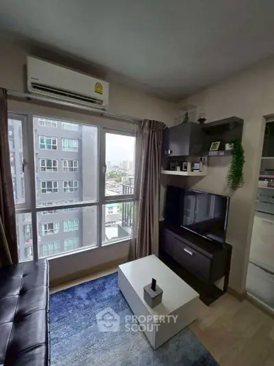 Modern living room with city view, sleek furniture, and natural light.