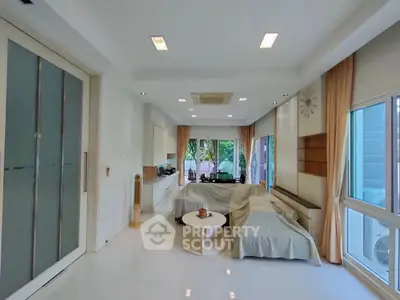 Spacious living room with modern decor and large windows offering natural light