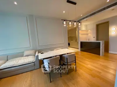 Modern living room with elegant dining area and stylish lighting in a contemporary apartment.