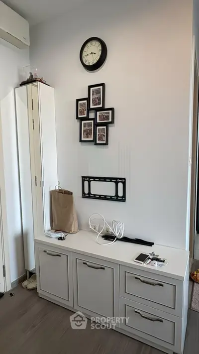 Modern interior with stylish storage unit and wall decor in a cozy living space.