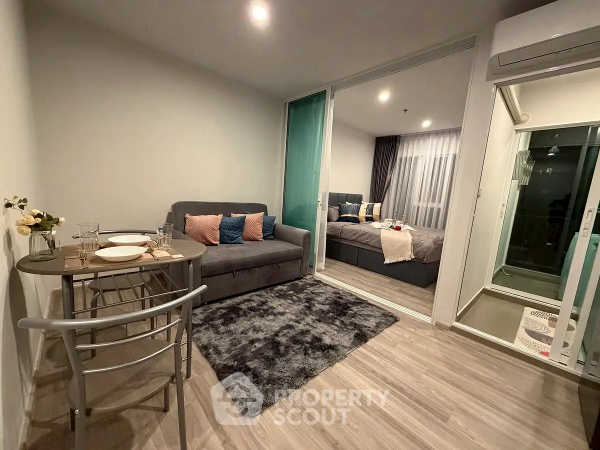 Modern living room with cozy sofa and dining area in open layout apartment