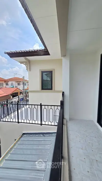 Charming balcony view with elegant railing and tiled floor in a modern residential building.