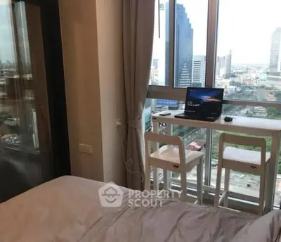 Modern bedroom with city view and cozy workspace by the window