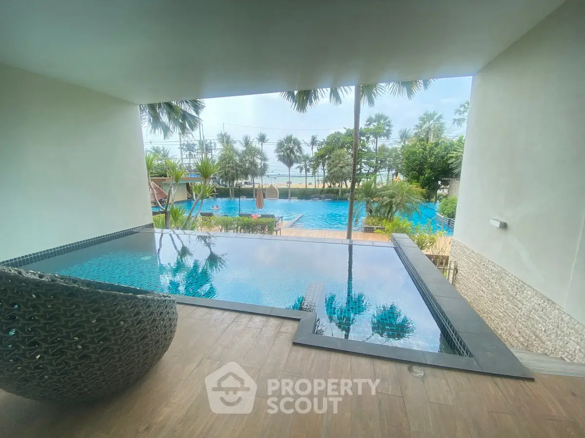Luxurious poolside view with palm trees and serene water features, perfect for relaxation and leisure.