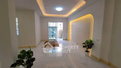 Spacious modern living room with elegant lighting and marble flooring