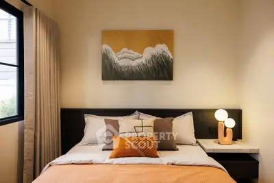 Cozy bedroom with modern decor and warm lighting, perfect for relaxation.