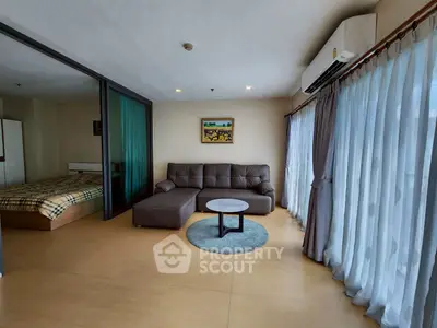 Spacious living room with modern sofa and large windows in a stylish apartment.