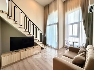Spacious modern living room with high ceilings and elegant staircase