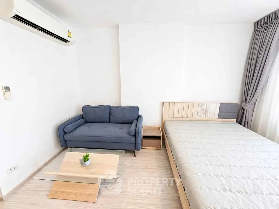 Modern minimalist bedroom with cozy sofa and stylish decor