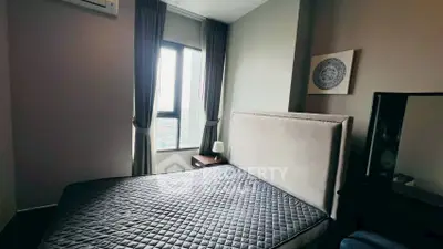 Cozy bedroom with modern decor and large window for natural light