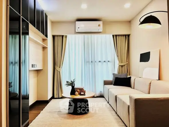 Modern living room with sleek design, featuring a comfortable sofa, stylish decor, and natural light.