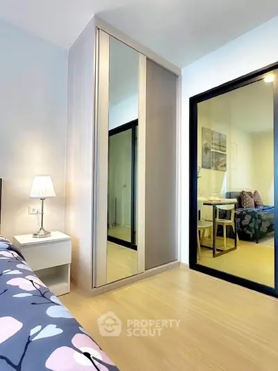 Modern bedroom with mirrored wardrobe and cozy decor