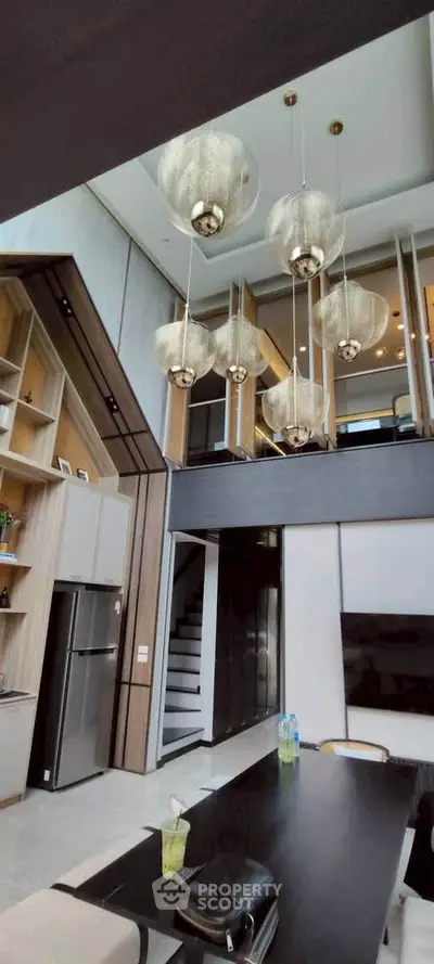 Luxurious modern living room with high ceilings and elegant pendant lights